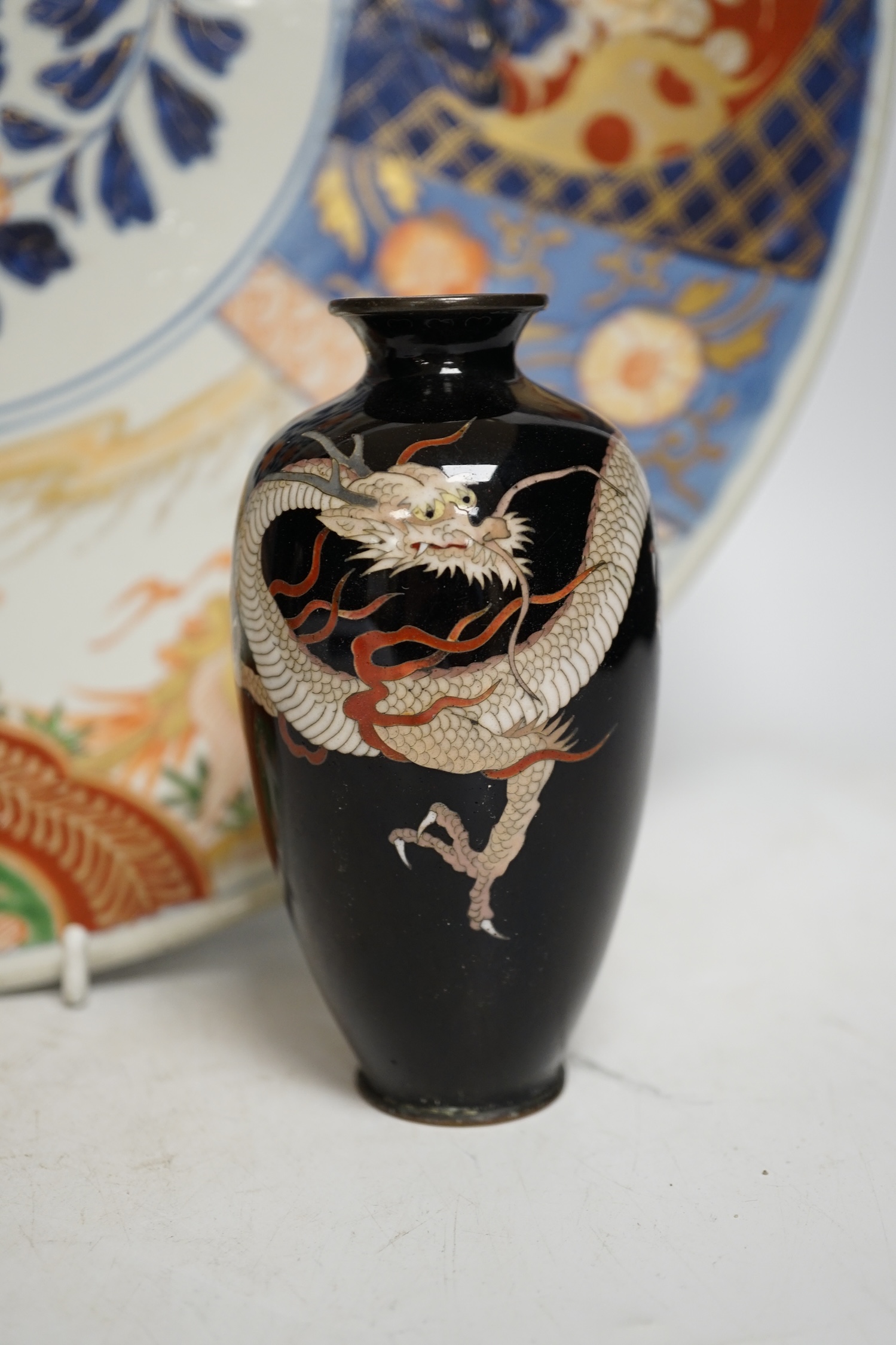 A pair of Japanese cloisonné enamel ‘dragon’ vases and a Japanese Imari dish, 39.5cm diameter (3). Condition - fair to good